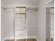 Walk-in closet with built-in shelving and hanging rods with wood floors at 3515 Centavo Ct, Hernando Beach, FL 34607