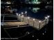 Nighttime view of private dock with illuminated railings, providing safe and scenic waterfront access at 3515 Centavo Ct, Hernando Beach, FL 34607