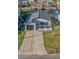 Charming waterfront home with a gray roof, attached garage, and well-maintained lawn near the canal at 3515 Centavo Ct, Hernando Beach, FL 34607