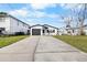 Inviting single-story home featuring a well-kept front yard and a long driveway to the attached garage at 3515 Centavo Ct, Hernando Beach, FL 34607