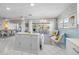 Open-concept living space with a kitchen island, modern lighting, and sliding glass doors to an outdoor area at 3515 Centavo Ct, Hernando Beach, FL 34607