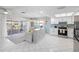 Stylish living space featuring stainless steel appliances, a kitchen island, and sliding doors to an outdoor patio at 3515 Centavo Ct, Hernando Beach, FL 34607
