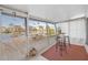 Enclosed patio boasting a waterfront view, a wooden deck, and an outdoor dining area at 3515 Centavo Ct, Hernando Beach, FL 34607