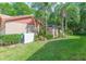 Lush green backyard featuring privacy landscaping, including palm trees and decorative plants at 3612 Darston St, Palm Harbor, FL 34685