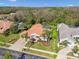 Aerial view showcases a home with landscaped backyard and paver driveway in quiet community at 3819 Brooksworth Ave, Tarpon Springs, FL 34688