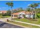 Aerial view of landscaped home with tile roof, paver driveway and verdant surroundings at 3819 Brooksworth Ave, Tarpon Springs, FL 34688