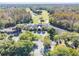 Aerial view of the clubhouse and golf course surrounded by trees and parking at 3819 Brooksworth Ave, Tarpon Springs, FL 34688