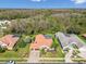Aerial view of tile-roofed houses, featuring a private pool in a lush, landscaped neighborhood at 3819 Brooksworth Ave, Tarpon Springs, FL 34688
