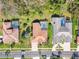 Aerial view of tile-roofed houses, featuring a private pool in a lush, landscaped neighborhood at 3819 Brooksworth Ave, Tarpon Springs, FL 34688