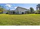 Expansive backyard with lush green lawn and screened-in lanai provides ample outdoor space at 3819 Brooksworth Ave, Tarpon Springs, FL 34688