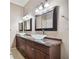 This bathroom boasts double sinks, granite countertops, and stylish lighting, offering a luxurious and functional space at 3819 Brooksworth Ave, Tarpon Springs, FL 34688