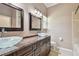 Elegant bathroom showcasing double sinks, granite counters, and wooden cabinets, creating a luxurious and inviting space at 3819 Brooksworth Ave, Tarpon Springs, FL 34688