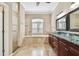Bright bathroom with shower, garden tub, tile floors, and dual vanity at 3819 Brooksworth Ave, Tarpon Springs, FL 34688