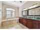 Bright bathroom with shower, garden tub, tile floors, and dual vanity at 3819 Brooksworth Ave, Tarpon Springs, FL 34688