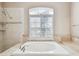 Bright bathroom featuring a large garden tub and tiled shower at 3819 Brooksworth Ave, Tarpon Springs, FL 34688
