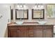 This bathroom features double sinks, elegant light fixtures, and a wood-look vanity, combining comfort and sophistication at 3819 Brooksworth Ave, Tarpon Springs, FL 34688