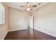 Cozy bedroom with hardwood floors, ceiling fan, and ample natural light from the window and entry way at 3819 Brooksworth Ave, Tarpon Springs, FL 34688