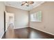 This bedroom is filled with natural light, wood-look floors, and features a ceiling fan for added comfort at 3819 Brooksworth Ave, Tarpon Springs, FL 34688