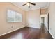 This bedroom offers wood-look floors, neutral walls, and a ceiling fan, creating a peaceful and inviting atmosphere at 3819 Brooksworth Ave, Tarpon Springs, FL 34688