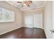 This cozy bedroom boasts a ceiling fan, wood-look floors, and a closet, offering simple charm and functionality at 3819 Brooksworth Ave, Tarpon Springs, FL 34688