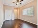 This bedroom features wood-look floors, neutral walls, and a ceiling fan, offering a blank canvas for personalization at 3819 Brooksworth Ave, Tarpon Springs, FL 34688