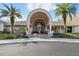 Stunning building entrance showcasing an arched entryway, columns, and beautiful landscaping at 3819 Brooksworth Ave, Tarpon Springs, FL 34688
