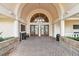 Elegant building entrance featuring arched doorways, brick paving, and decorative glass doors at 3819 Brooksworth Ave, Tarpon Springs, FL 34688