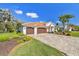 A beautiful home with a tile roof, three-car garage, and well-manicured landscaping at 3819 Brooksworth Ave, Tarpon Springs, FL 34688