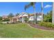 Well-maintained home featuring a lush green lawn, mature trees, and a tile roof at 3819 Brooksworth Ave, Tarpon Springs, FL 34688