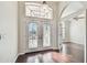 Elegant foyer with hardwood floors, double doors, and an open view into the home at 3819 Brooksworth Ave, Tarpon Springs, FL 34688
