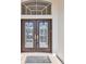 Detailed view of the front door with decorative glass and a 'Welcome' mat at 3819 Brooksworth Ave, Tarpon Springs, FL 34688