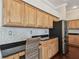 Charming kitchen featuring light wood cabinetry, granite counters, and stainless steel refrigerator at 3819 Brooksworth Ave, Tarpon Springs, FL 34688