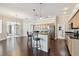 Open-concept kitchen with wood cabinetry, an island with bar seating, and wood floors throughout the space at 3819 Brooksworth Ave, Tarpon Springs, FL 34688