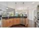 Kitchen featuring an island with seating, stainless steel appliances, and an open layout to the living areas at 3819 Brooksworth Ave, Tarpon Springs, FL 34688
