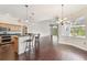 Open-concept kitchen featuring dark wood floors and an island with seating at 3819 Brooksworth Ave, Tarpon Springs, FL 34688