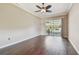 Living room featuring hardwood floors, a ceiling fan, and sliding glass doors leading to the pool at 3819 Brooksworth Ave, Tarpon Springs, FL 34688