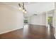 Spacious living room with hardwood floors, access to the screened patio, and a ceiling fan at 3819 Brooksworth Ave, Tarpon Springs, FL 34688