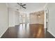 Spacious living room with hardwood floors, archways, ceiling fan, and French doors to the entrance at 3819 Brooksworth Ave, Tarpon Springs, FL 34688