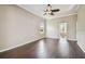 Spacious living room boasts hardwood floors, a ceiling fan, and a view into the primary bath at 3819 Brooksworth Ave, Tarpon Springs, FL 34688