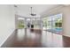 Bright living room with high ceilings, large windows, a fireplace, and hardwood floors overlooking the pool at 3819 Brooksworth Ave, Tarpon Springs, FL 34688