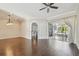 This living room features hardwood floors, an archway, and access to the screened in patio with an outdoor kitchen at 3819 Brooksworth Ave, Tarpon Springs, FL 34688