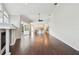 Large open living area offering seamless flow to the kitchen and featuring a fireplace and hardwood flooring at 3819 Brooksworth Ave, Tarpon Springs, FL 34688