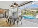 Inviting patio with outdoor table near the pool, perfect for alfresco dining and relaxation at 3819 Brooksworth Ave, Tarpon Springs, FL 34688