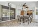 Charming tiled patio with ceiling fan, leading to pool area through glass doors at 3819 Brooksworth Ave, Tarpon Springs, FL 34688