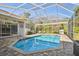 Relaxing enclosed pool area with clear blue water and ample seating at 3819 Brooksworth Ave, Tarpon Springs, FL 34688