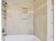 This shower features tiled walls, modern fixtures, and a built-in niche for a spa-like experience at 3819 Brooksworth Ave, Tarpon Springs, FL 34688