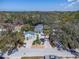 Aerial view of the property showcasing its lush surroundings, charming home, and convenient location at 410 Georgia Ave, Crystal Beach, FL 34681