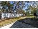 Spacious backyard with partial fencing and mature trees at 410 Georgia Ave, Crystal Beach, FL 34681