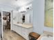 Light filled bathroom with double sinks, vanity and linen closet at 410 Georgia Ave, Crystal Beach, FL 34681