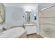 Light blue bath with tub, walk-in shower and vanity with a beachy feel at 410 Georgia Ave, Crystal Beach, FL 34681